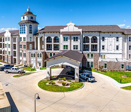 Modern Building Exterior With Palm Trees at Assisted Living Facility Outdoor Entrance of Assisted Living Facility
