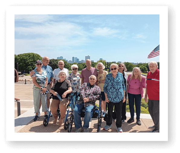 Group of Seniors Enjoying Outdoor Event in Assisted Living Facility