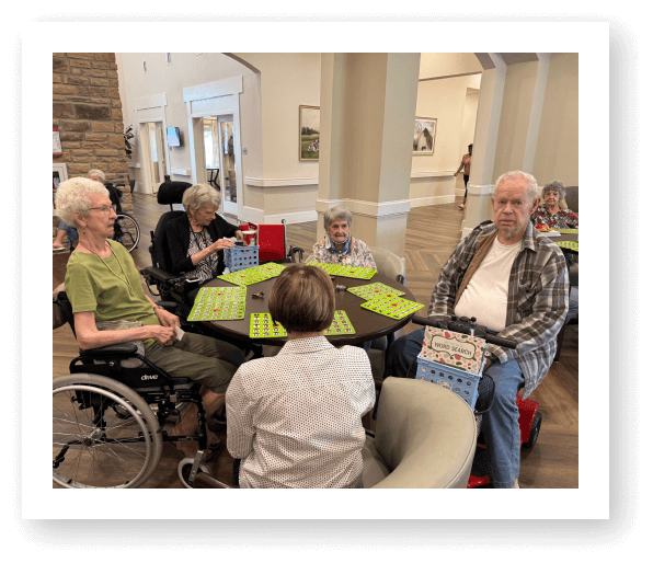 Group of Senior Friends Enjoying a Conversation in Memory Care Facility