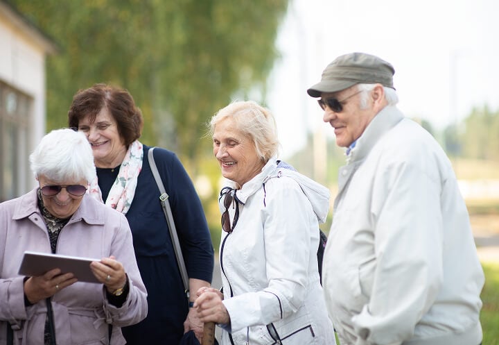 Group of Elderly People Enjoying Hike Near Assisted Living Facility Group of Elderly People Enjoying Hike Near Assisted Living Facility