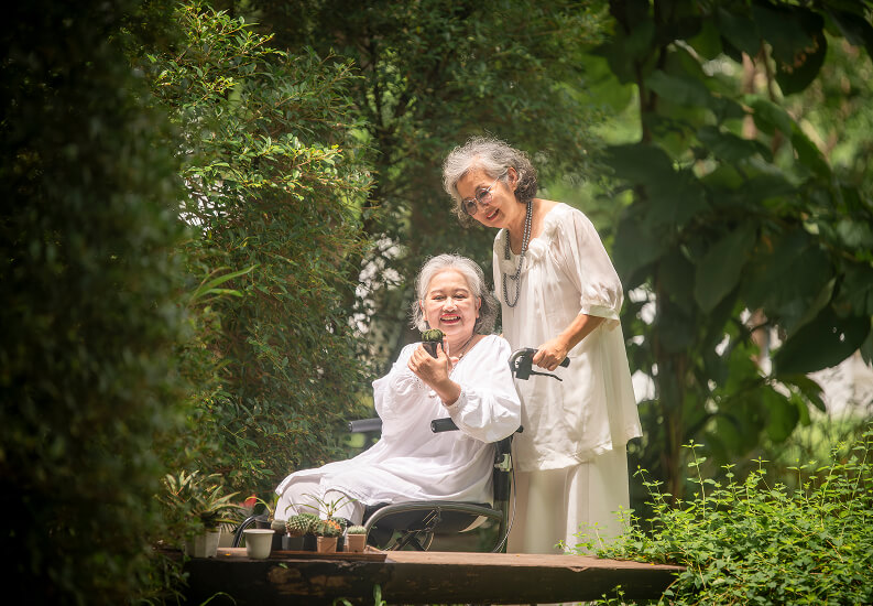 Two Elderly Friends Enjoying the Outdoors Near Dementia Care Facility Two Elderly Friends Enjoying the Outdoors Near Dementia Care Facility