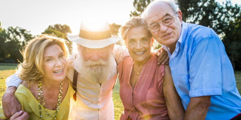 Group of Seniors Celebrating Together Outdoors at Assisted Living Facility